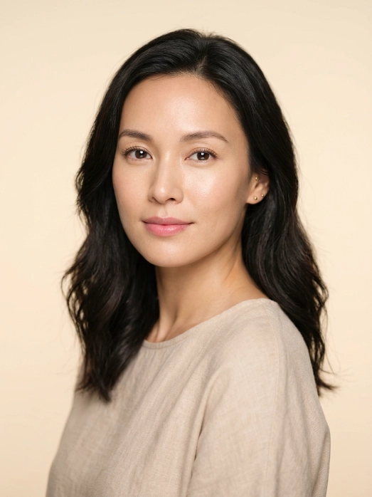A glowing woman with firm smooth complexion against a warm sand background, representing the benefits of Juvelook.