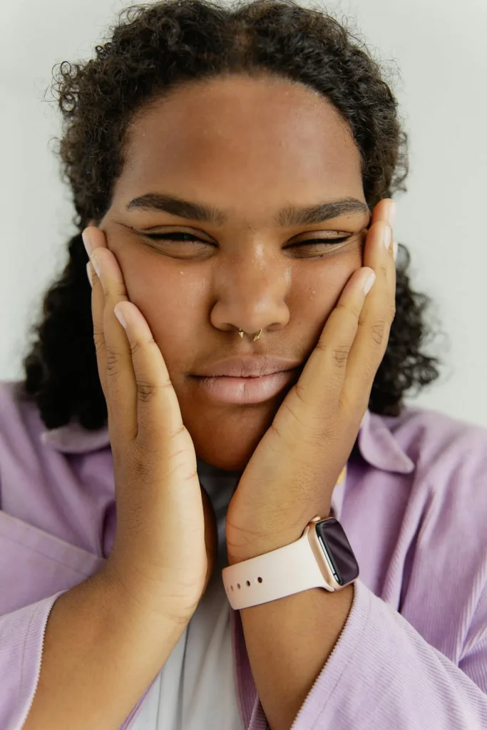 Patient experiencing facial swelling, redness, and skin irritation due to an allergic reaction after a dermal filler procedure.