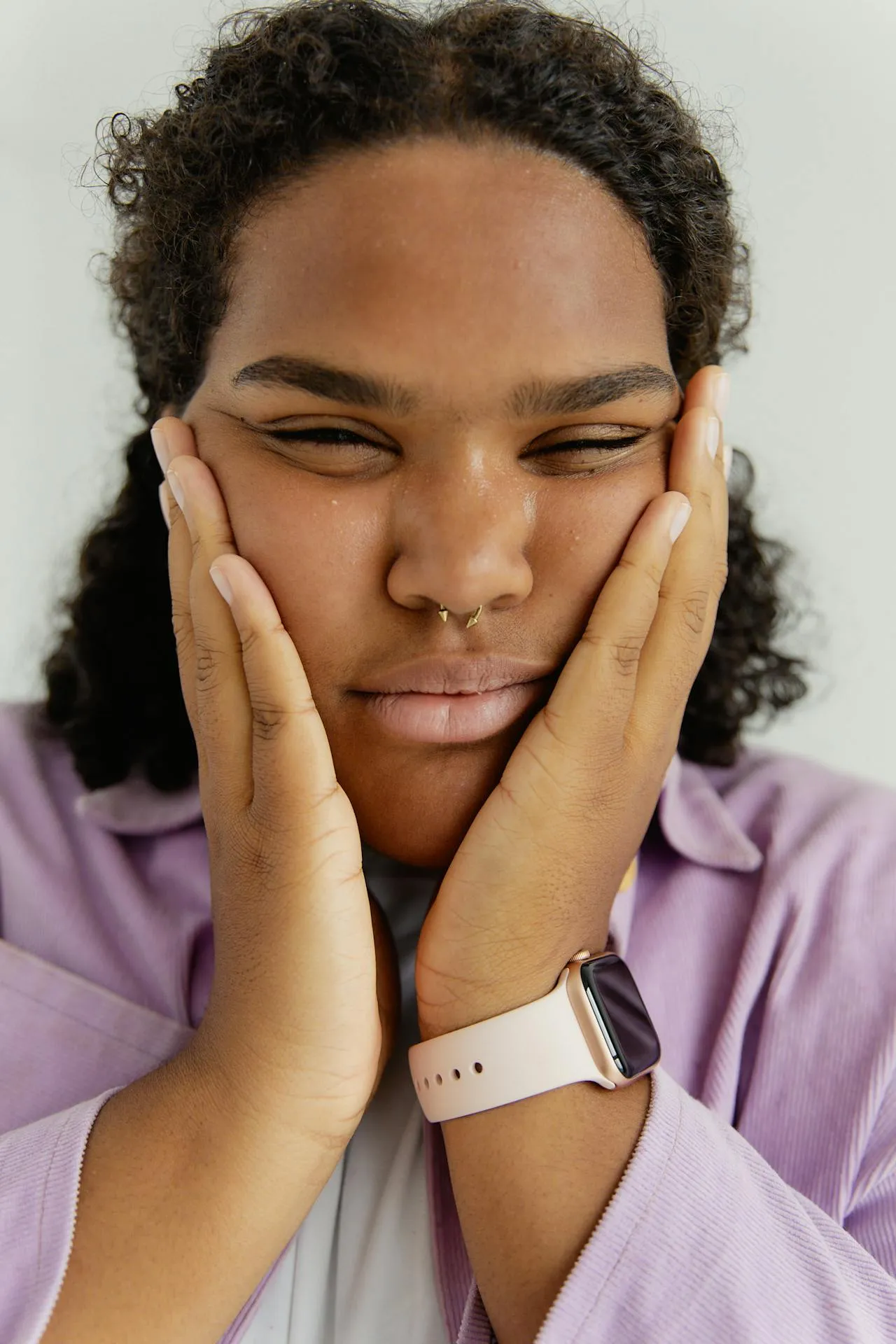 Patient experiencing facial swelling, redness, and skin irritation due to an allergic reaction after a dermal filler procedure.