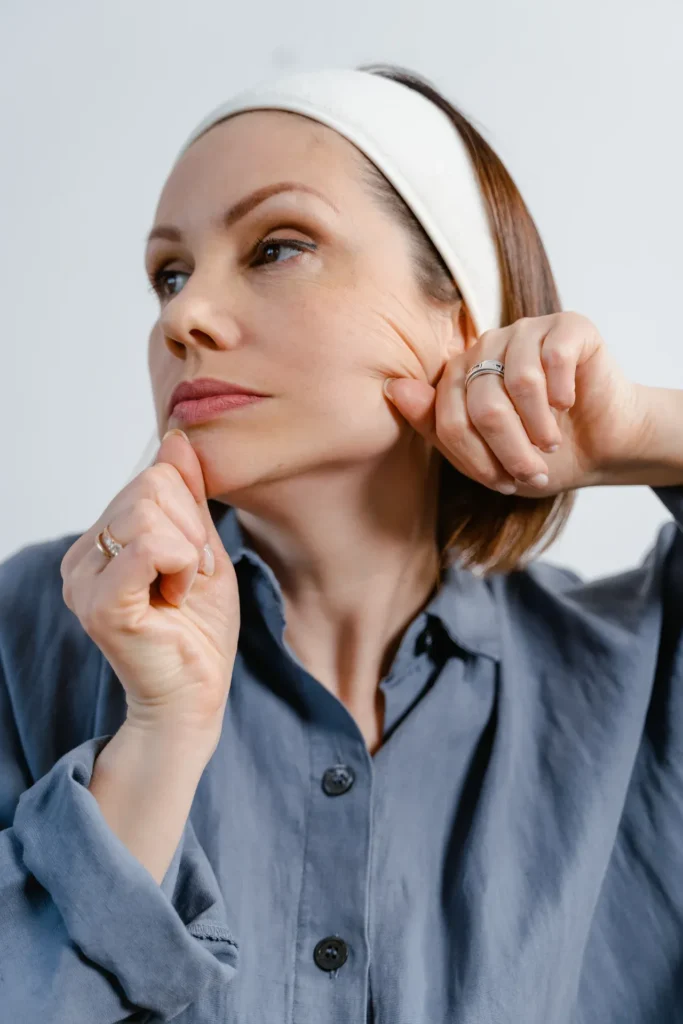 Person massaging face and applying skincare products as part of a routine to support smoother texture and overall skin quality