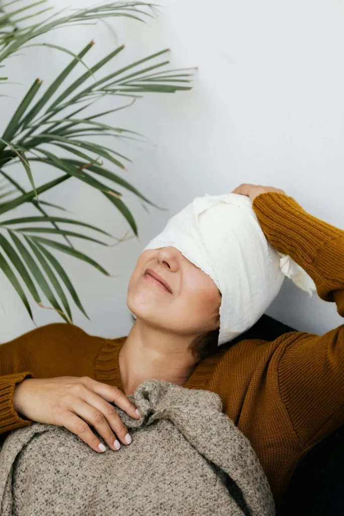 Woman having a headache after aesthetic treatment procedure