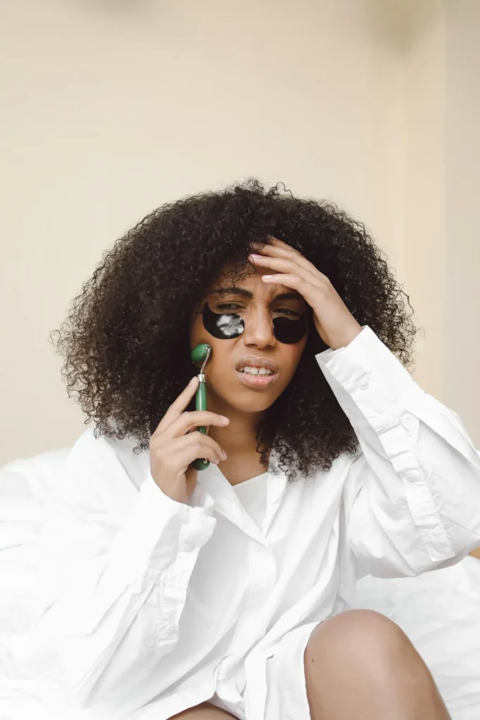 Woman looking confused while using multiple skincare products during her beauty routine