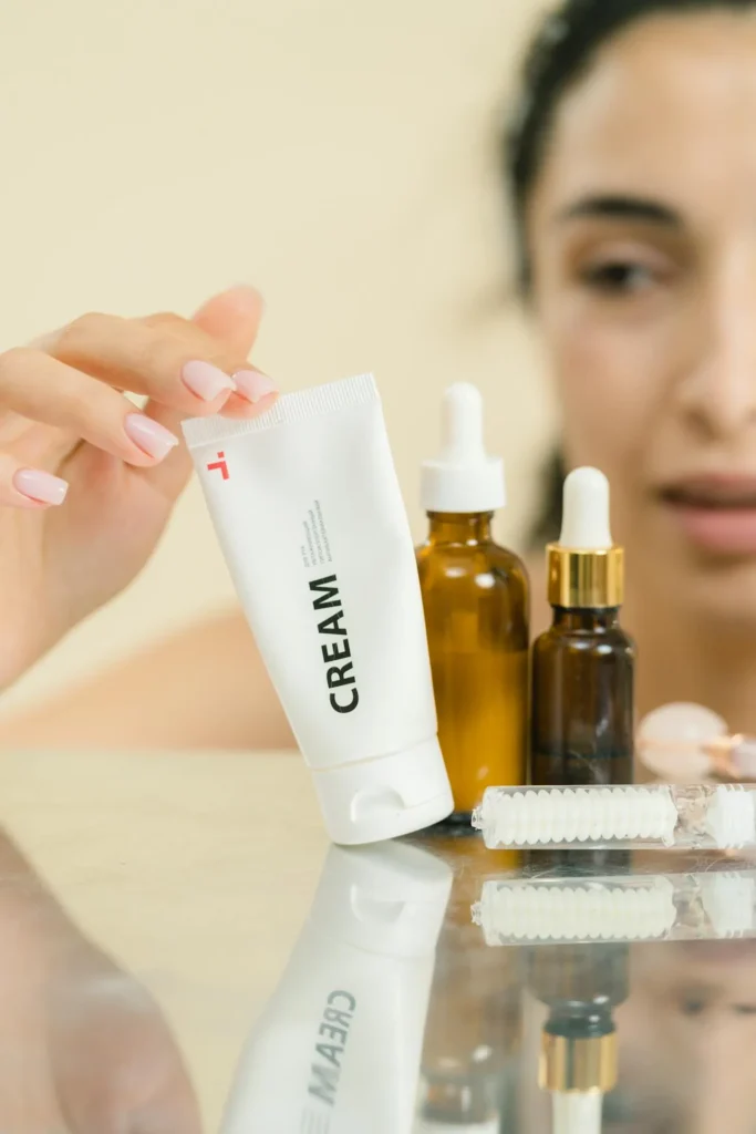 Collection of daily skincare products, including cleanser, moisturiser, sunscreen, and serum, on bathroom counter
