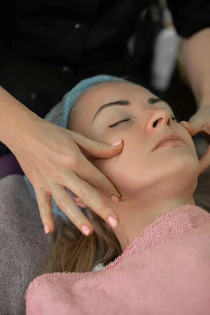 Skincare specialist assessing facial skin condition before creating a personalised microneedling treatment schedule.