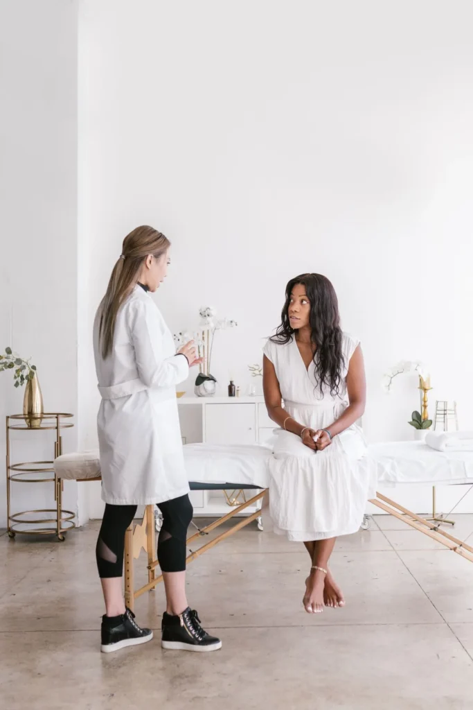 Cosmetic practitioner consulting patient about injectable moisturiser safety, risks, and potential side effects before treatment