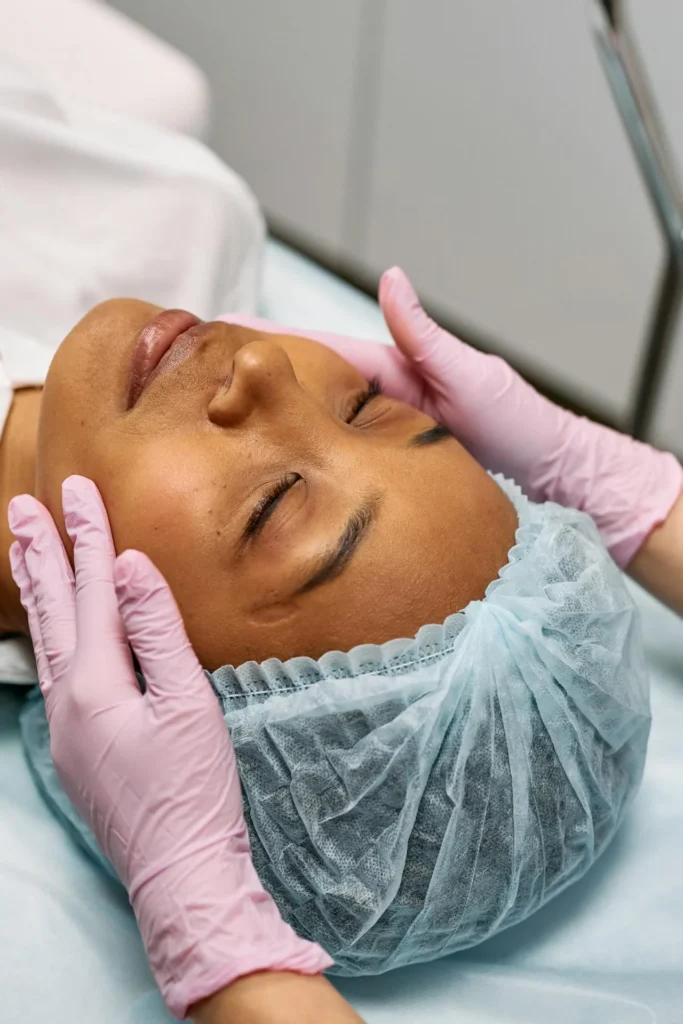 Aesthetic practitioner assessing facial movement, texture changes, and structural factors during a consultation