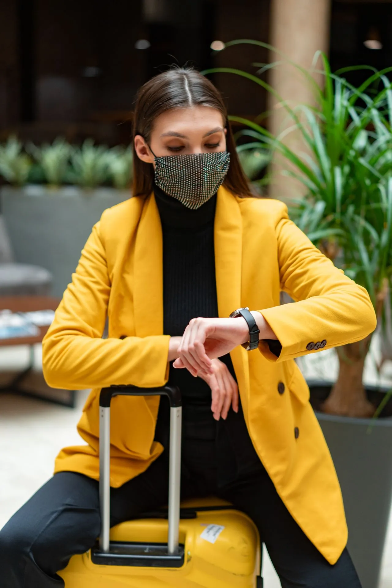 Female patient checking travel schedule after dermal filler treatment while consulting recovery guidelines