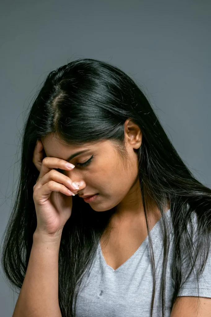 Patient showing redness, swelling, and discomfort following cosmetic dermal filler injections.