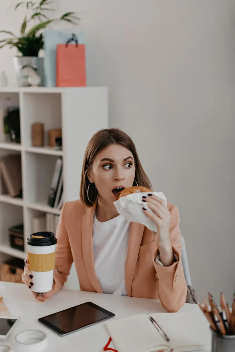 Woman eating salty food and drinking coffee, which are advised to avoid before lip filler treatment