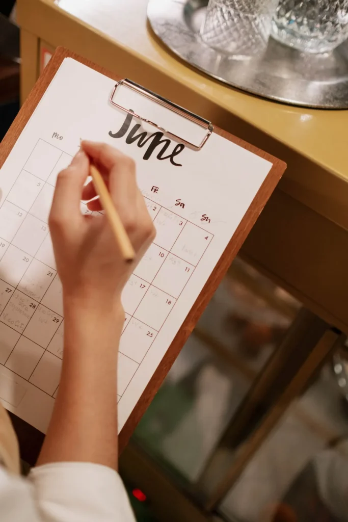 Person checking a calendar while preparing for a dermal filler appointment and avoiding caffeine