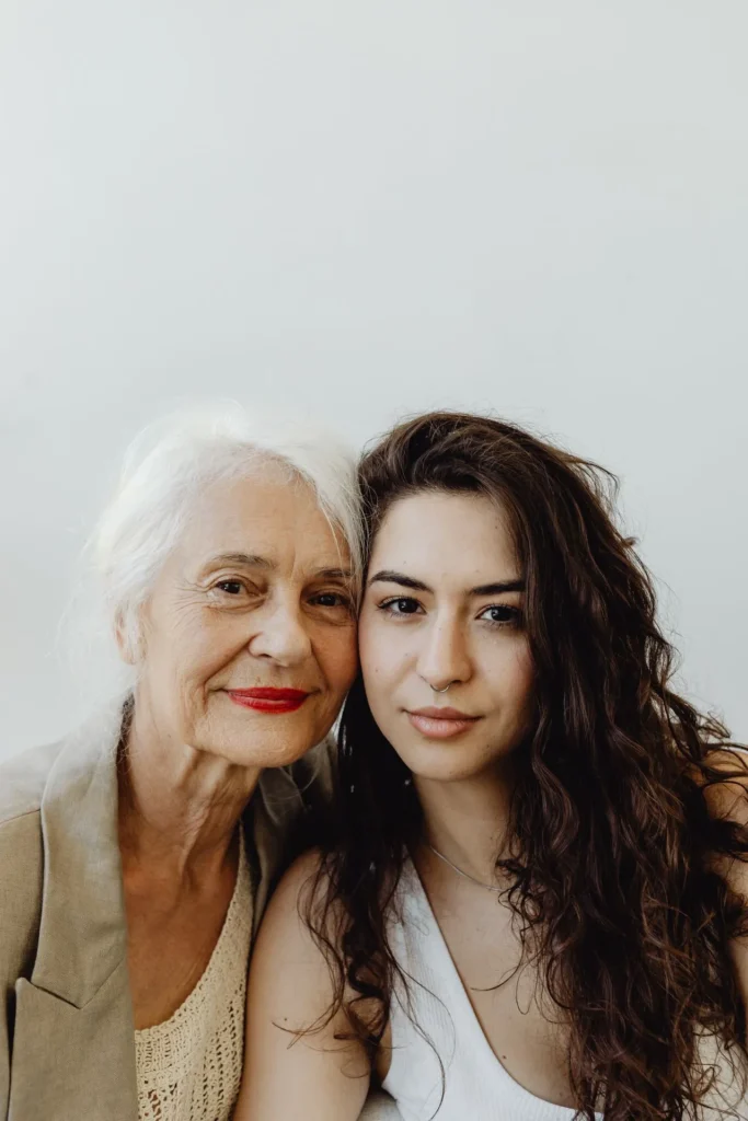 Young and mature women with healthy, glowing complexions together in a studio