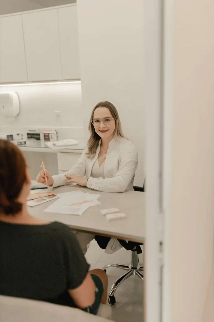 Practitioner consulting patient before dermal filler treatment