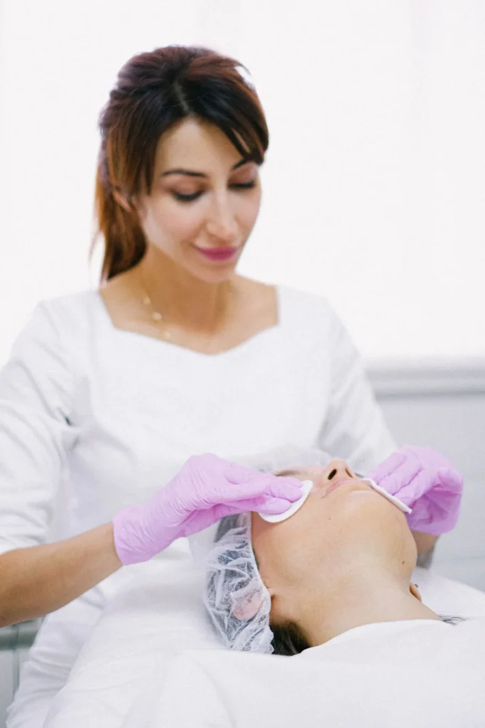 Patient consulting aesthetic practitioner before cheek filler treatment.