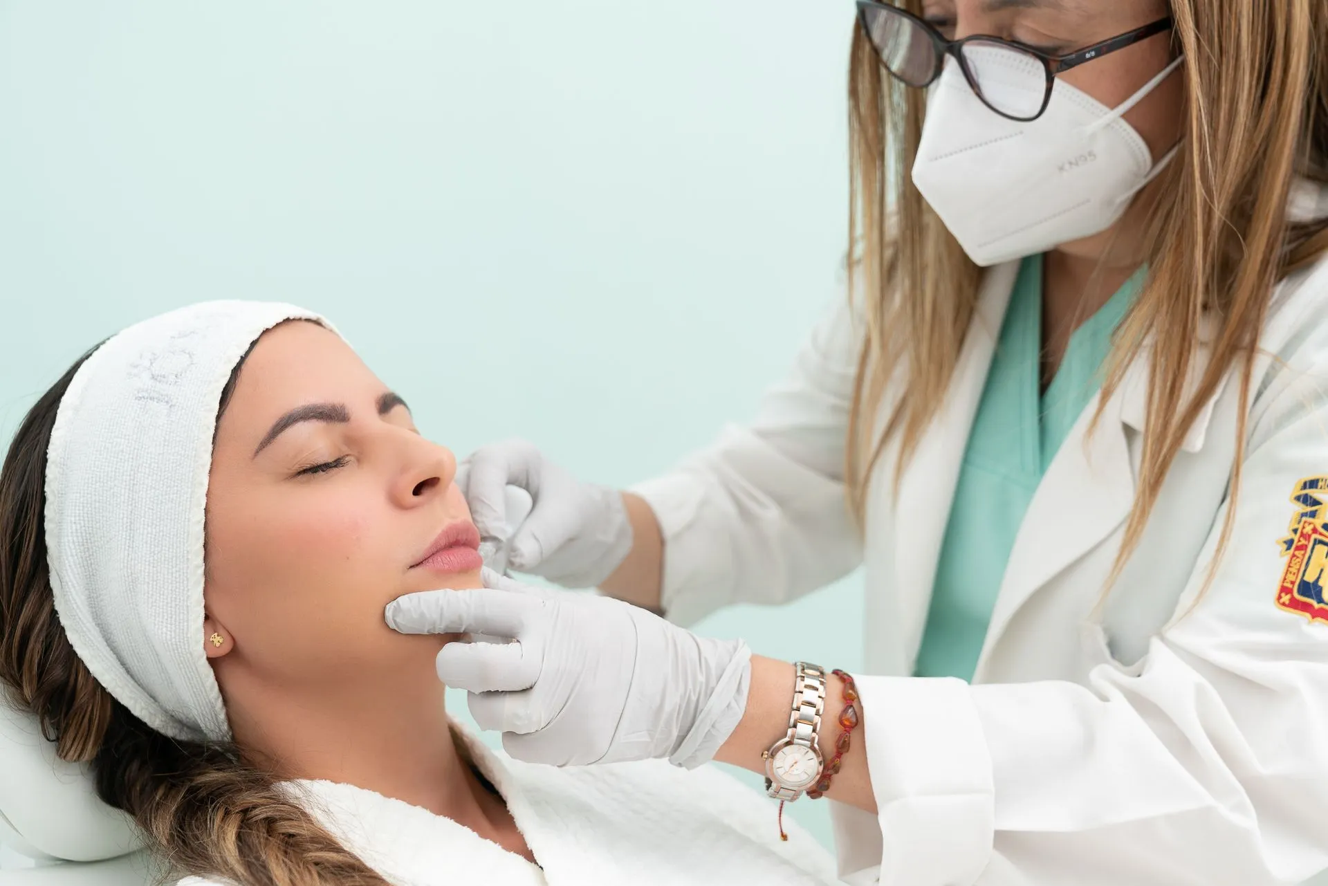 Practitioner consulting a patient before nasolabial fold filler treatment