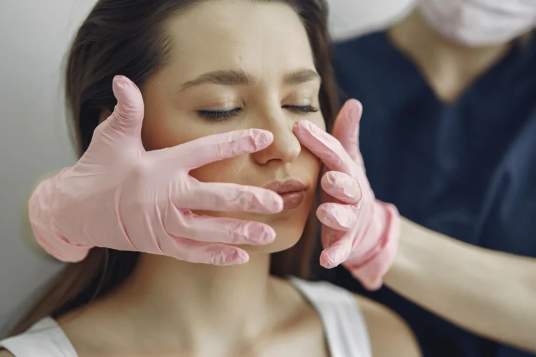 Practitioner marking nasolabial fold injection points before dermal filler procedure