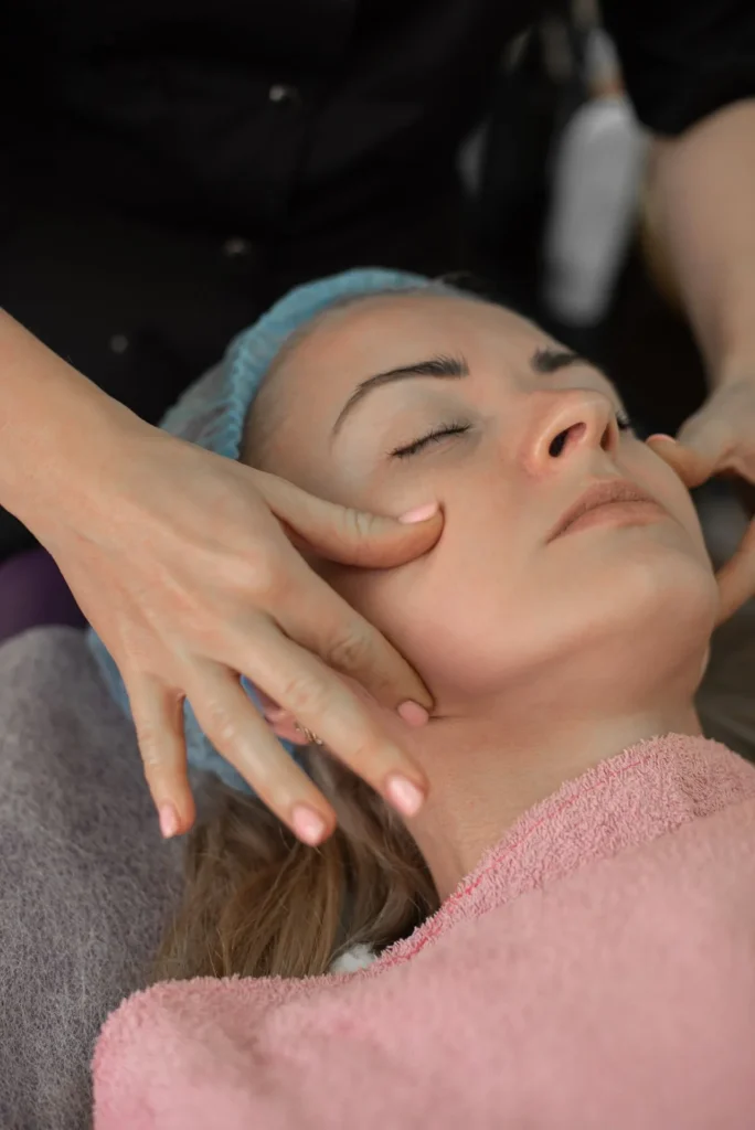 Medical professional disinfecting skin before dermal filler injection procedure