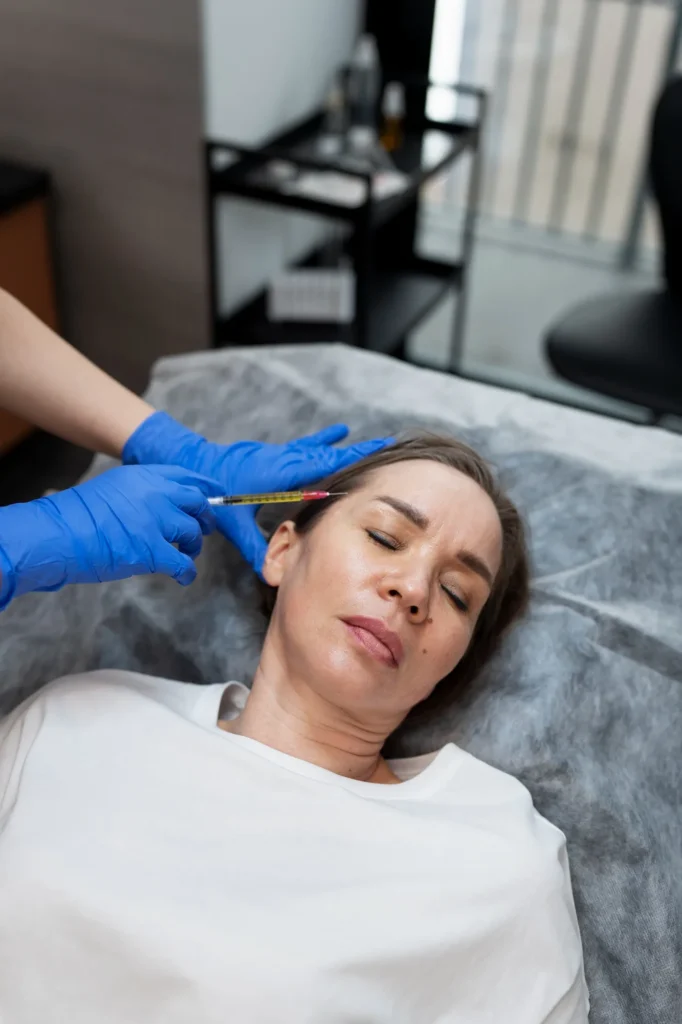 Medical professional performing temple filler injection